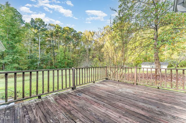 a view of house with a yard and potted plants