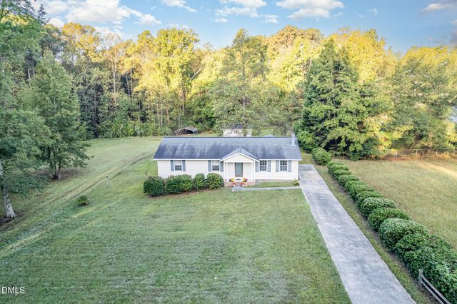 a view of a field with trees in the background