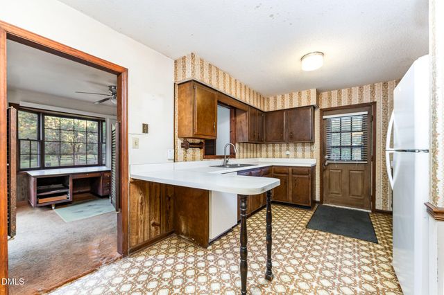 a view of a kitchen with furniture and a fireplace