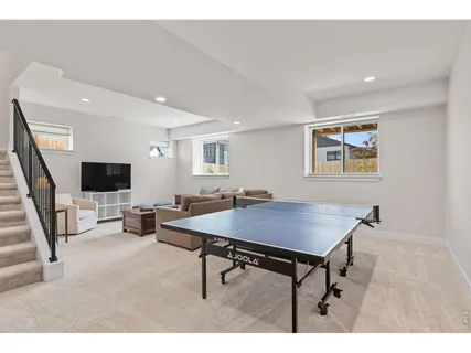 a living room with furniture a lamp and a flat screen tv