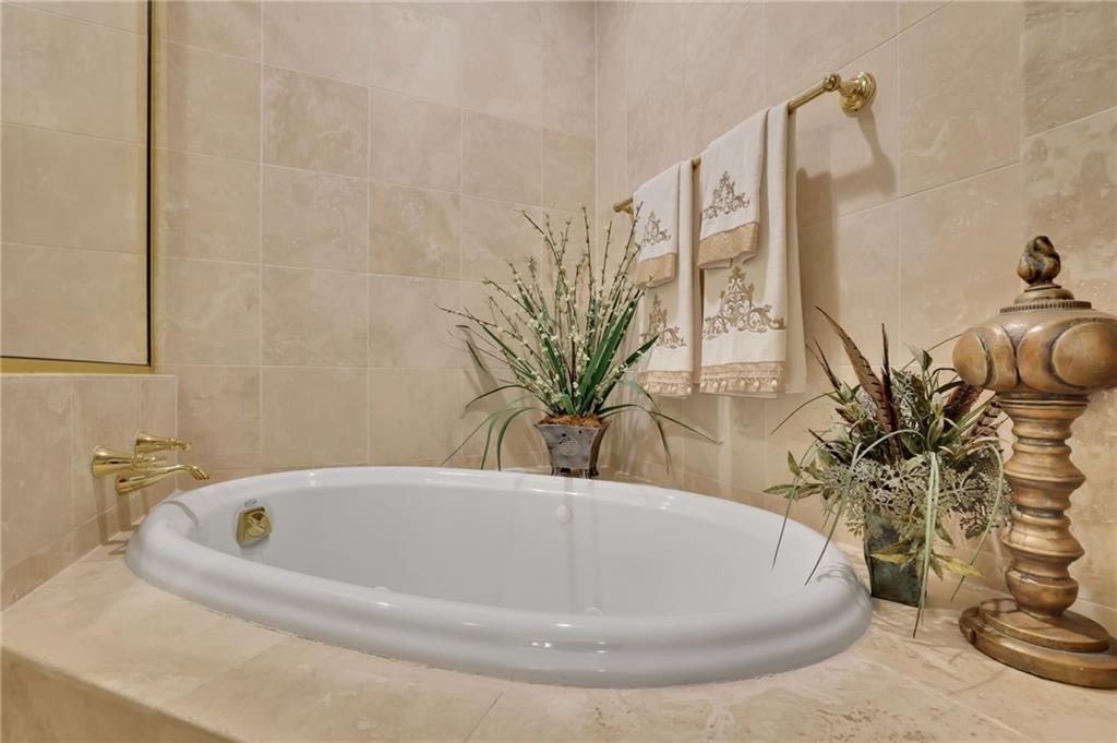 2828 Peachtree Road Northwest, Unit 1901 Atlanta, GA 30305 - Photo 21 of 35 a white bath tub sitting in a bathroom