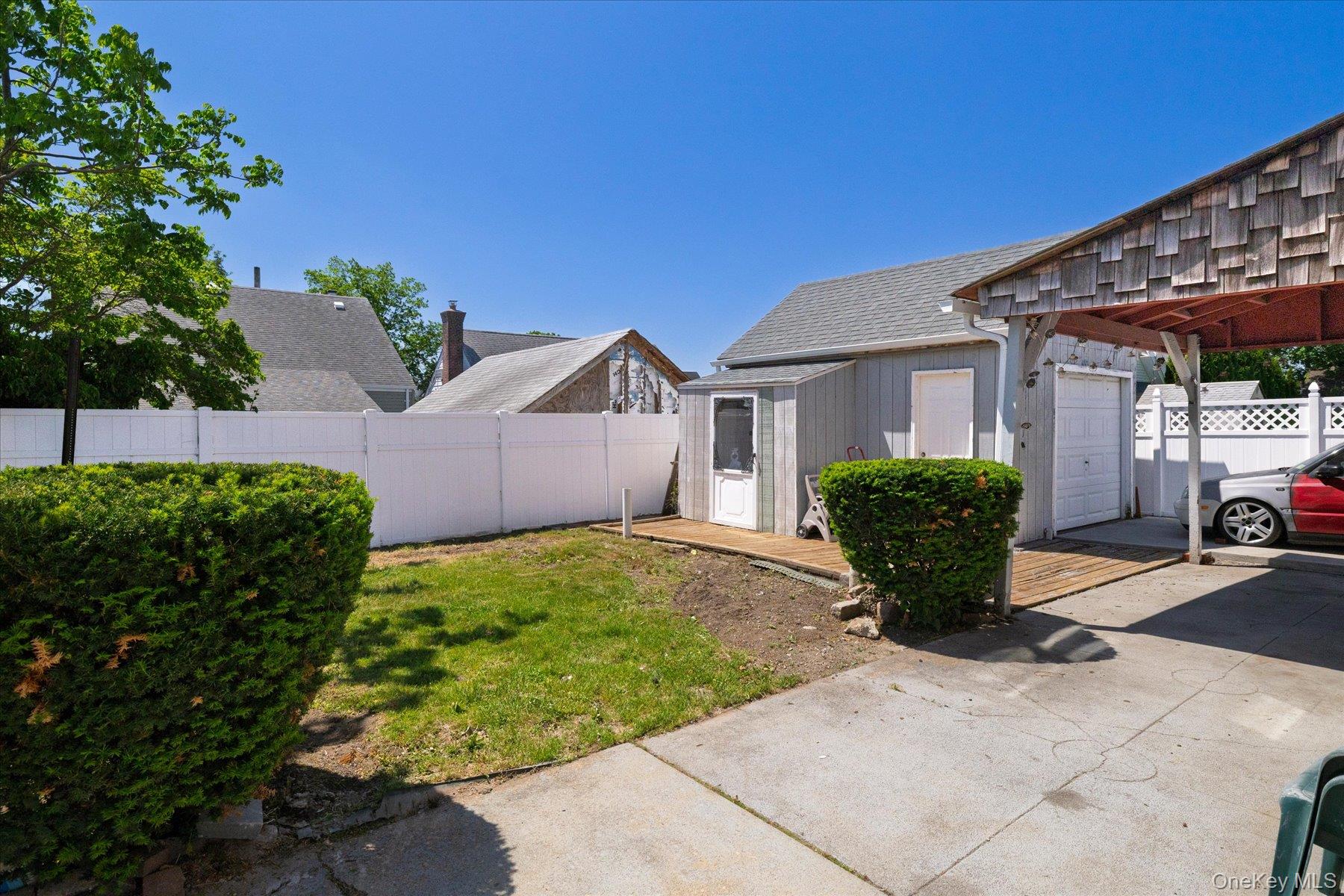 191 Raff Avenue Mineola, NY 11501 - Photo 5 of 25 a view of a house with backyard and a garden