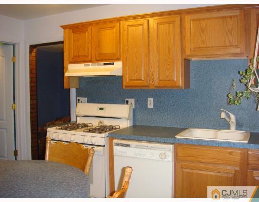 14 Purdue Road Old Bridge, NJ 08859 - Photo 4 of 9 a kitchen with stainless steel appliances granite countertop a stove a sink and a microwave