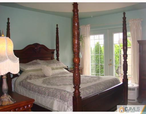 14 Purdue Road Old Bridge, NJ 08859 - Photo 6 of 9 a bed sitting in a bedroom next to a window