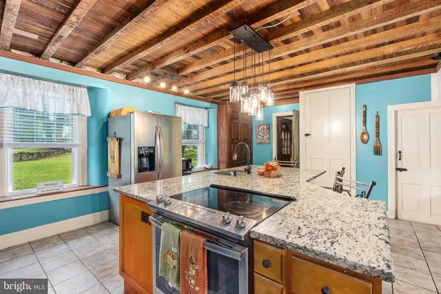 a dining room with furniture a chandelier and wooden floor
