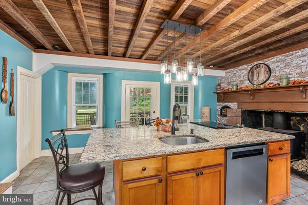 a living room with furniture a large window and a fireplace