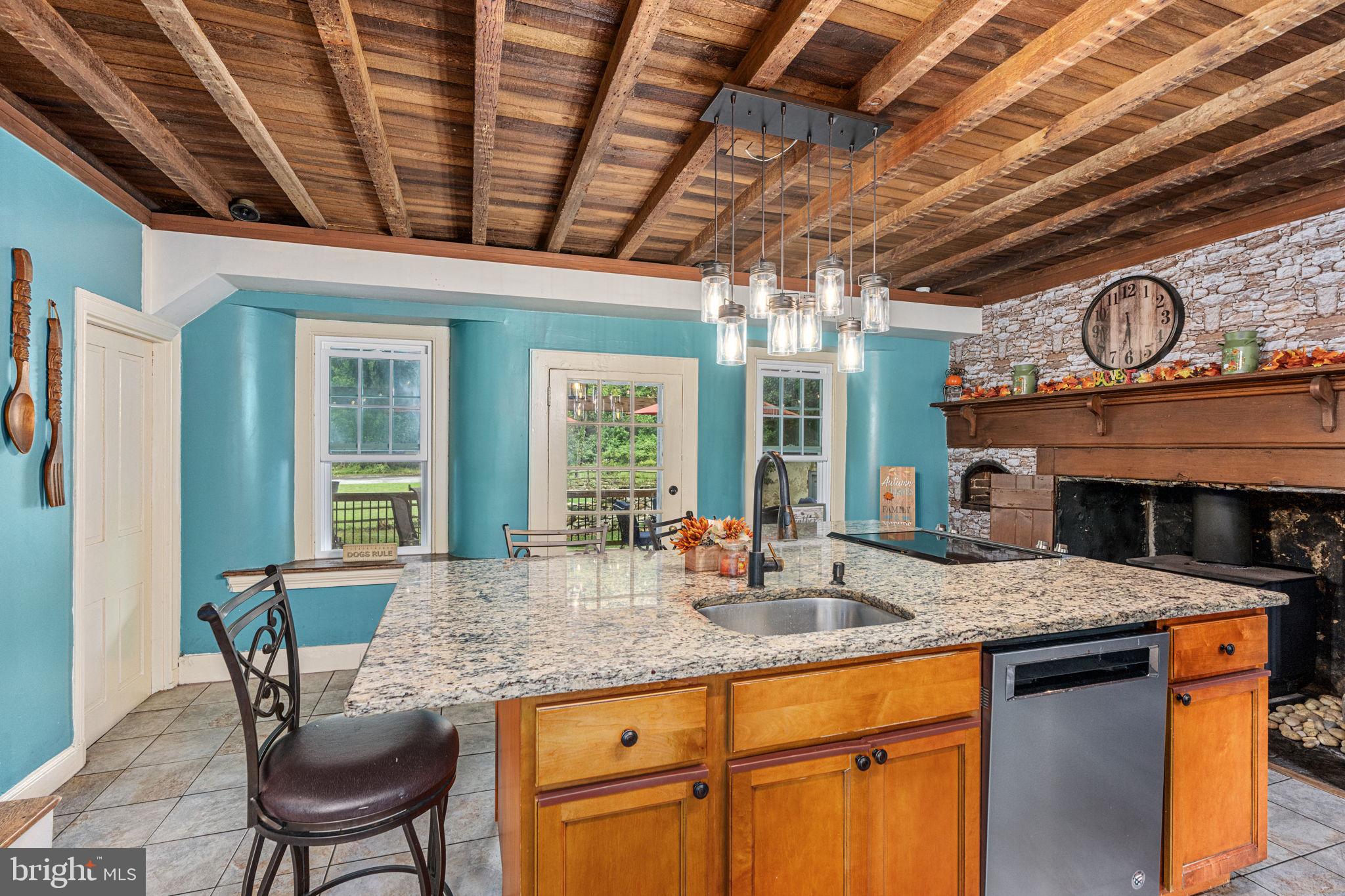 4701 Edges Mill Road Downingtown, PA 19335 - Photo 17 of 74 a kitchen with granite countertop a sink and a wooden floors
