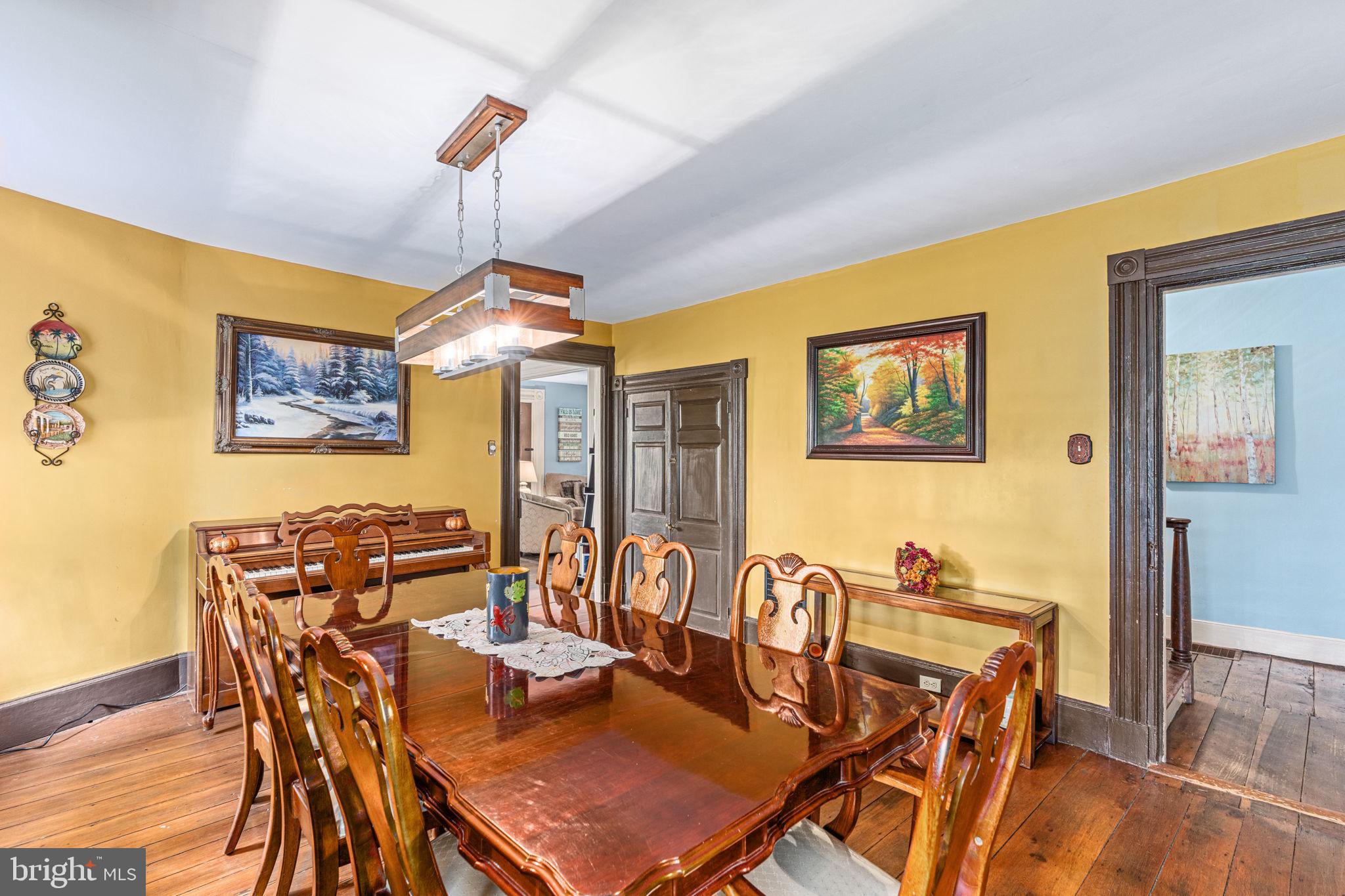 4701 Edges Mill Road Downingtown, PA 19335 - Photo 23 of 74 a dining room with furniture a chandelier and wooden floor