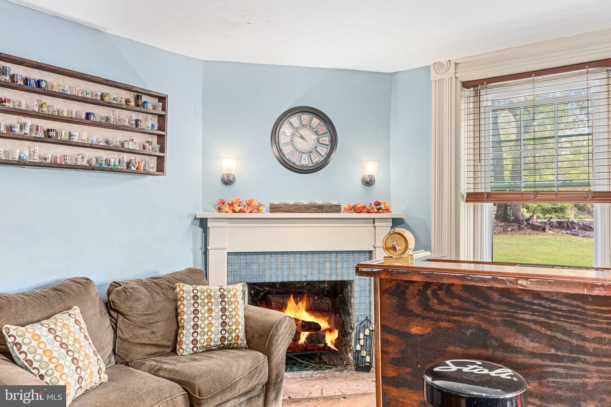 4701 Edges Mill Road Downingtown, PA 19335 - Photo 28 of 74 a living room with furniture a large window and a fireplace