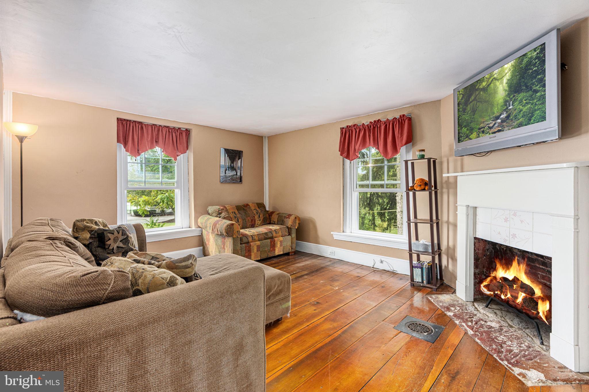 4701 Edges Mill Road Downingtown, PA 19335 - Photo 45 of 74 a living room with furniture fireplace and window