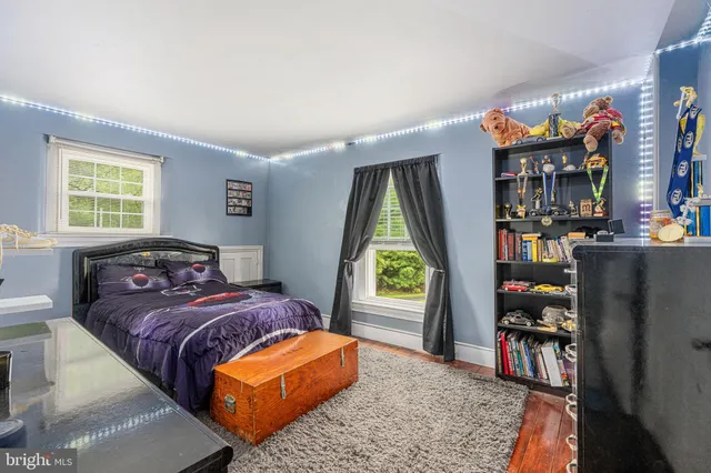 a aerial view of a house with swimming pool next to a yard