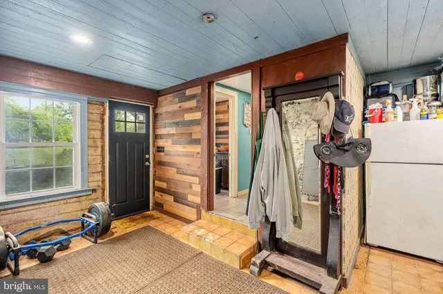 a kitchen with granite countertop a sink and a wooden floors