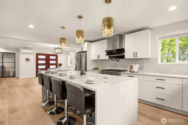 a kitchen with a stove a refrigerator and a sink