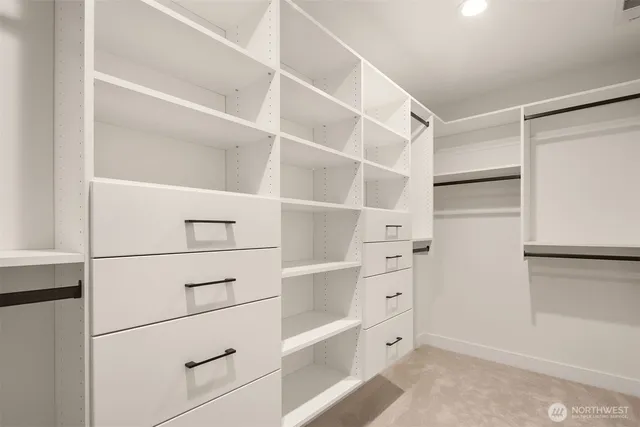a view of walk in closet with empty racks