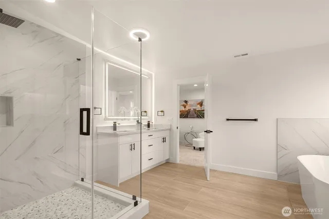 a large bathroom with a granite countertop sink mirror and shower