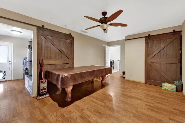 a living room with wooden floor and furniture