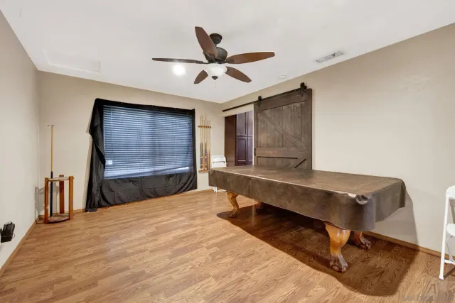 a bedroom with a bed and a ceiling fan