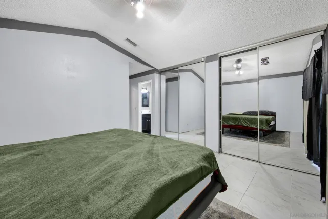 a bedroom with a bed and a mirror