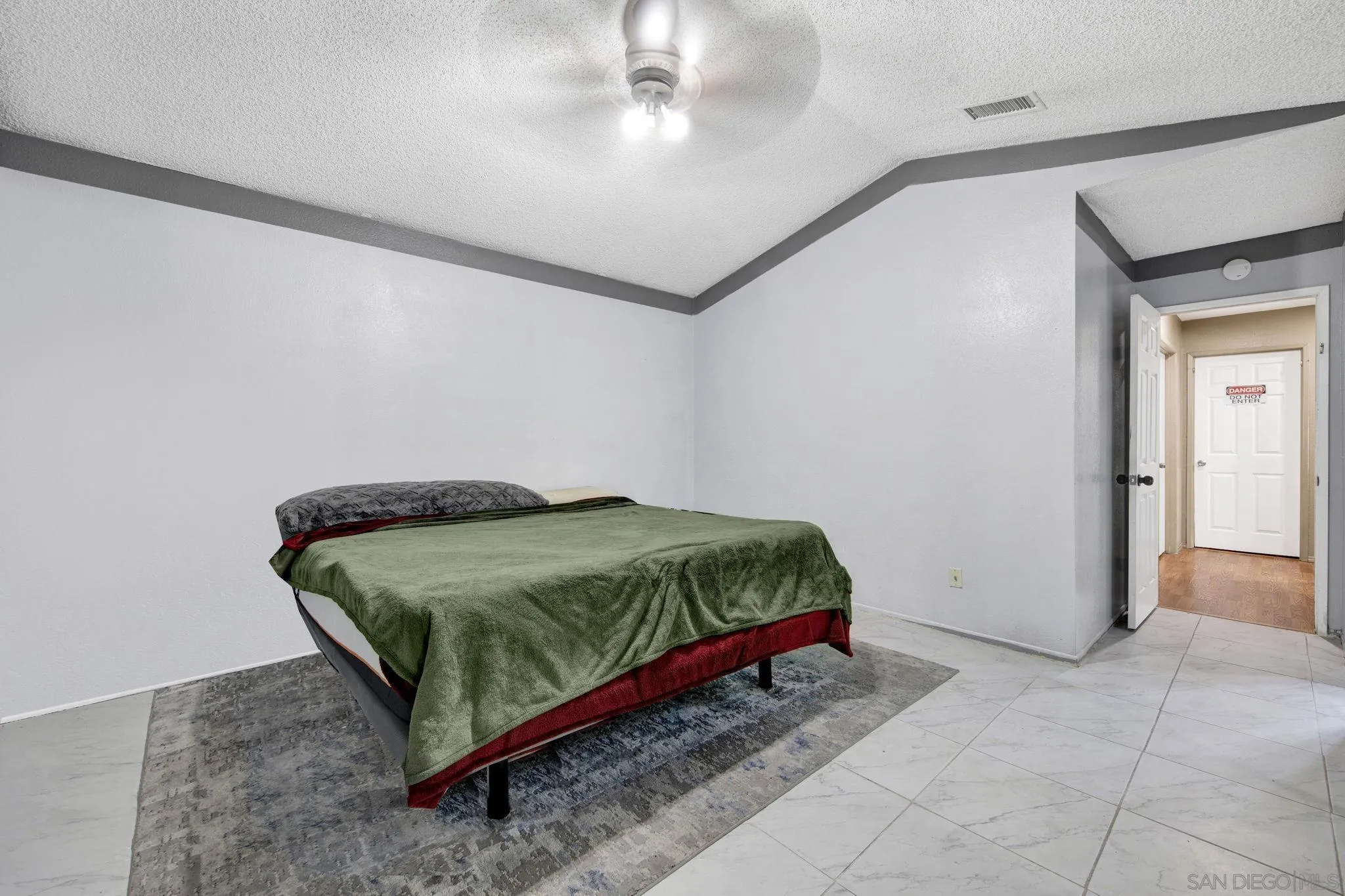 2772 Cincinnati Street West San Bernardino, CA 92407 - Photo 22 of 41 a bedroom with a bed and a chandelier fan