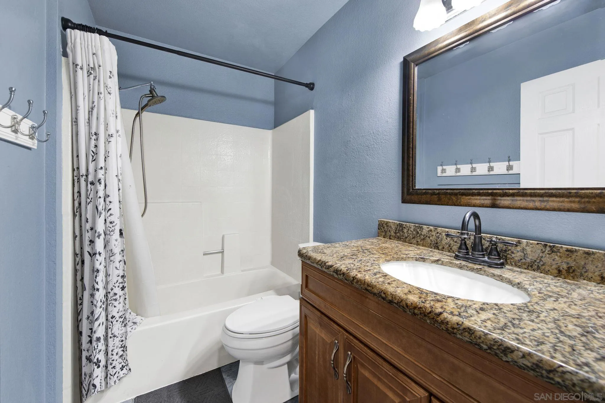 2772 Cincinnati Street West San Bernardino, CA 92407 - Photo 23 of 41 a bathroom with a granite countertop sink toilet and shower
