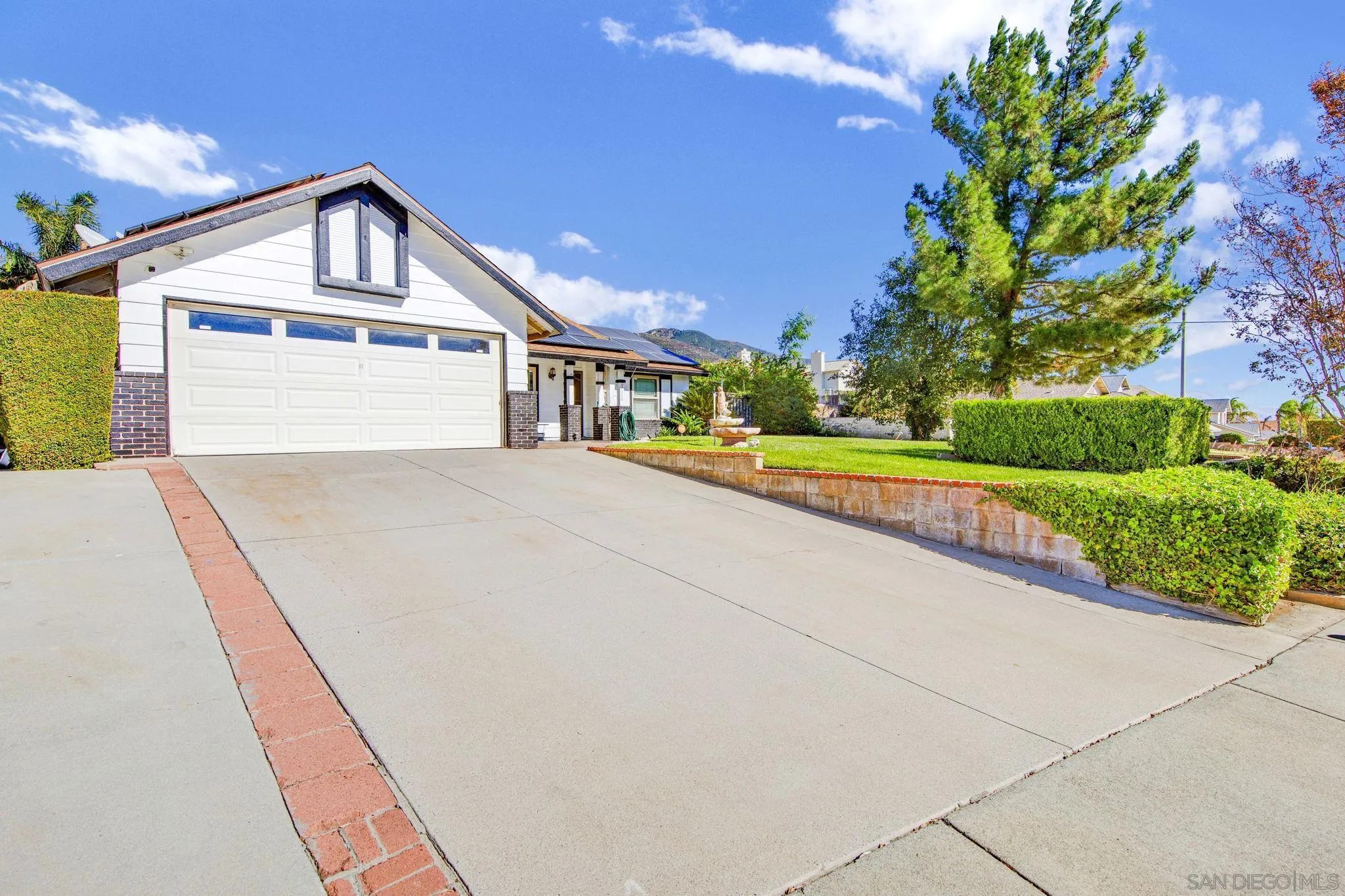 2772 Cincinnati Street West San Bernardino, CA 92407 - Photo 3 of 41 a front view of a house with a yard and garage