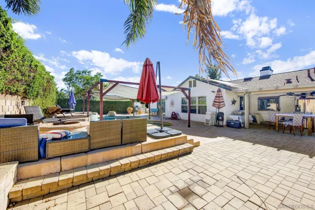 a view of a patio with couches and a fire pit
