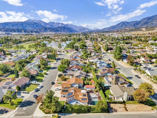 a view of a city with lots of residential buildings ocean and mountain view in back