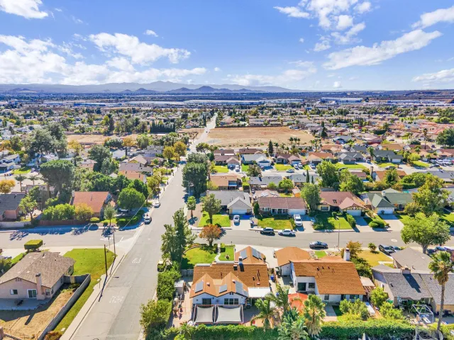 aerial view of multi story residential apartment building with yard
