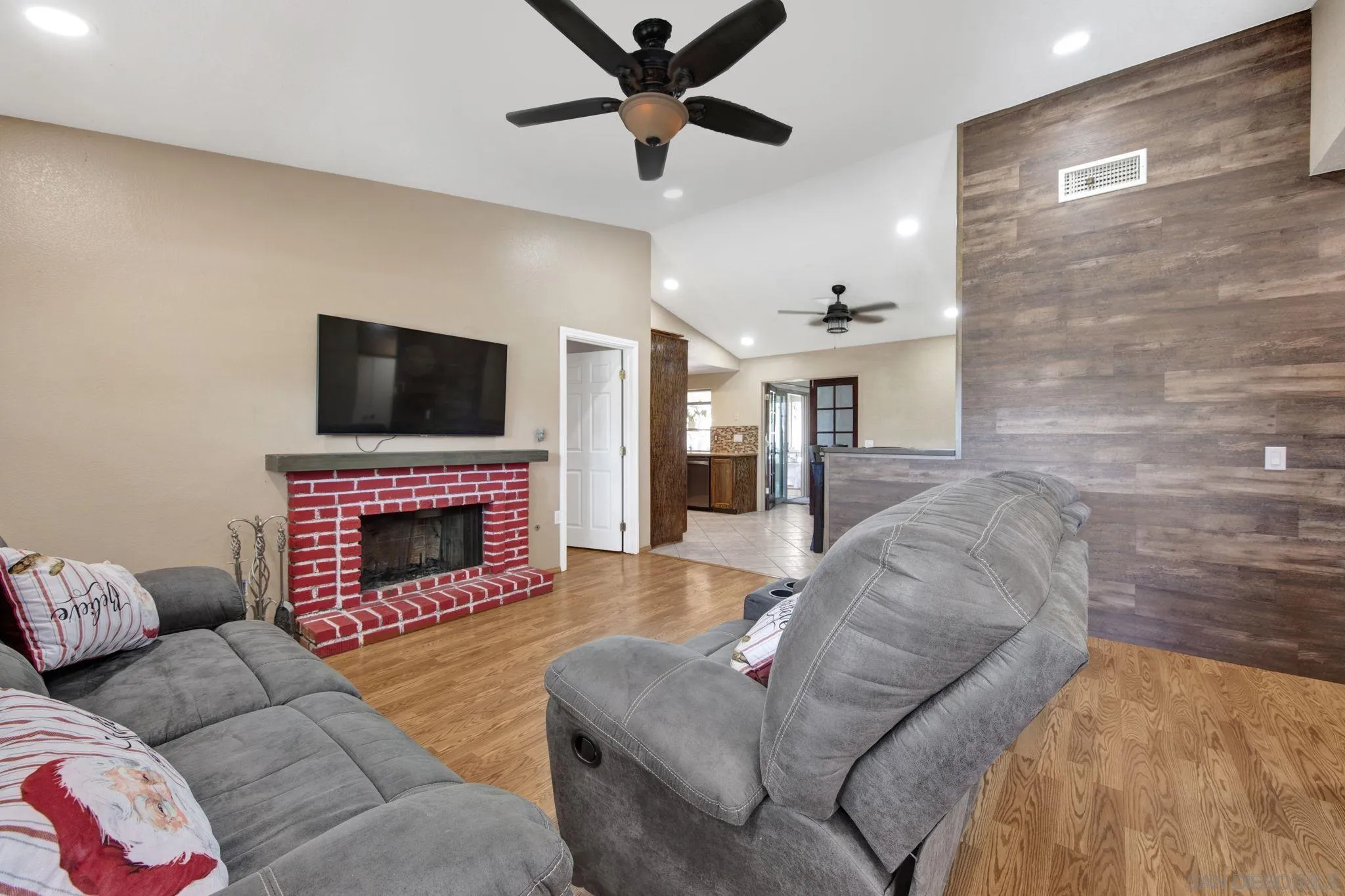 2772 Cincinnati Street West San Bernardino, CA 92407 - Photo 5 of 41 a living room with furniture a fireplace and a flat screen tv