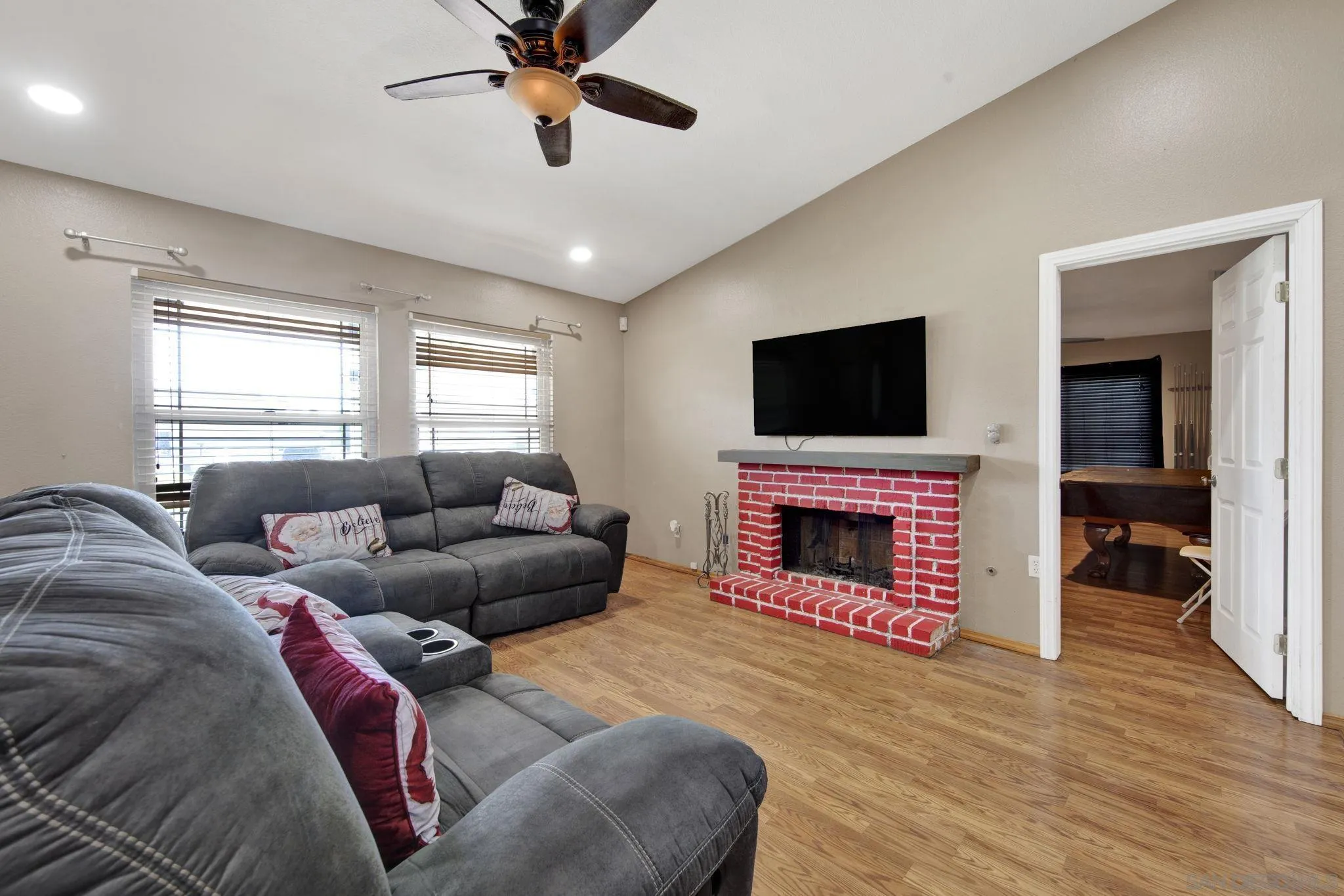 2772 Cincinnati Street West San Bernardino, CA 92407 - Photo 8 of 41 a living room with furniture a fireplace and a flat screen tv