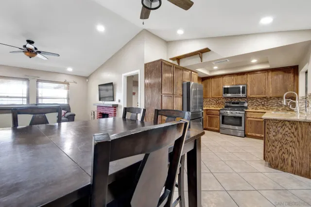 a kitchen with stainless steel appliances granite countertop a stove refrigerator sink and cabinets