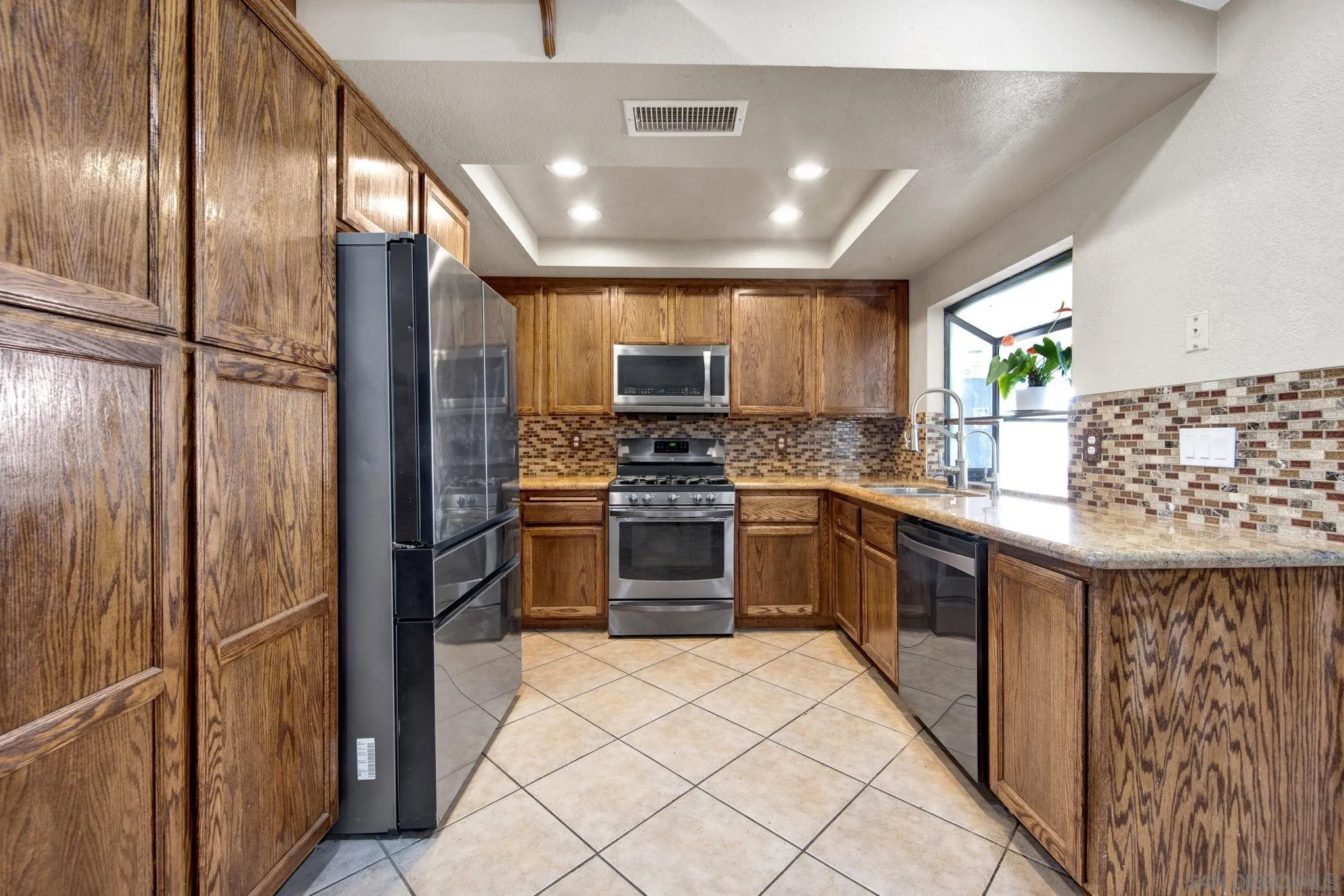 2772 Cincinnati Street West San Bernardino, CA 92407 - Photo 10 of 41 a kitchen with stainless steel appliances granite countertop a stove and a refrigerator