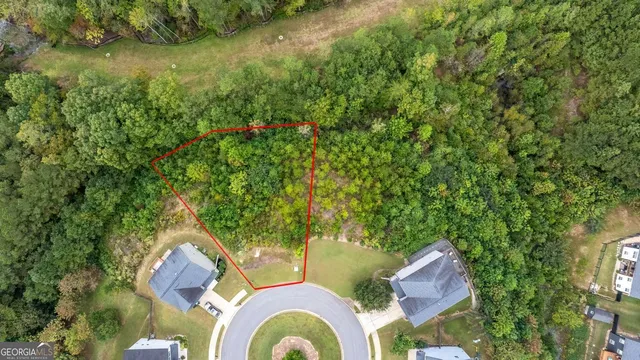 an aerial view of residential house with outdoor space and trees around
