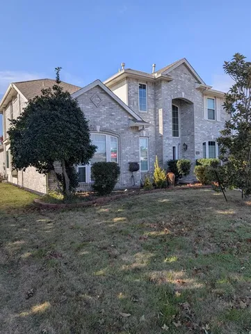 a view of a backyard with couches under an umbrella