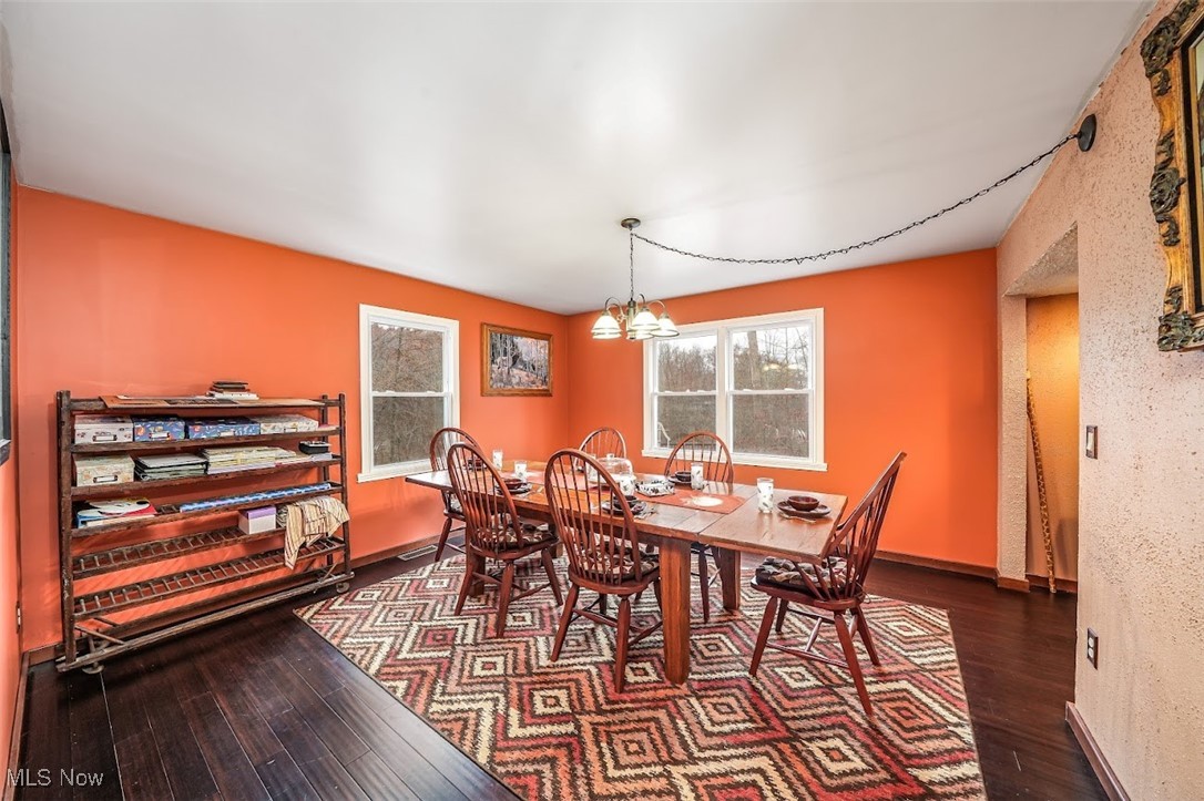 17808 Nash Road Middlefield, OH 44062 - Photo 18 of 43 Dining space with dark wood finished floors and a chandelier