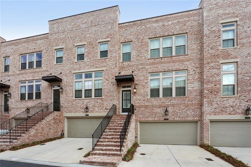 a front view of a house with many windows