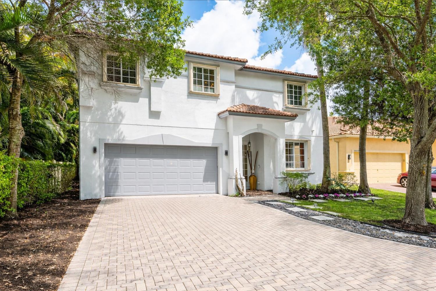 10223 Boca Vista Drive Boca Raton, FL 33498 - Photo 1 of 33 a front view of a house with a garden