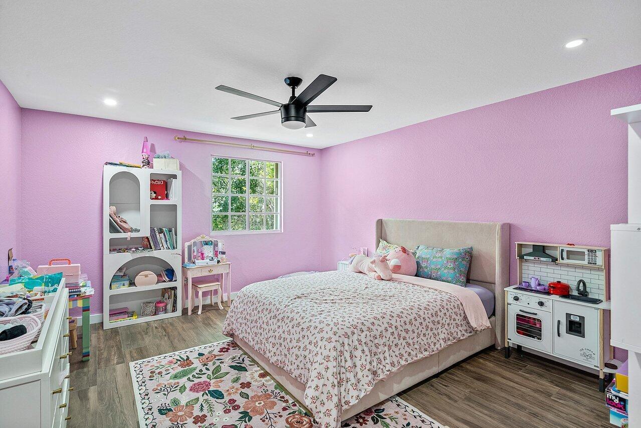 10223 Boca Vista Drive Boca Raton, FL 33498 - Photo 20 of 33 a bedroom with a bed a dresser and a window