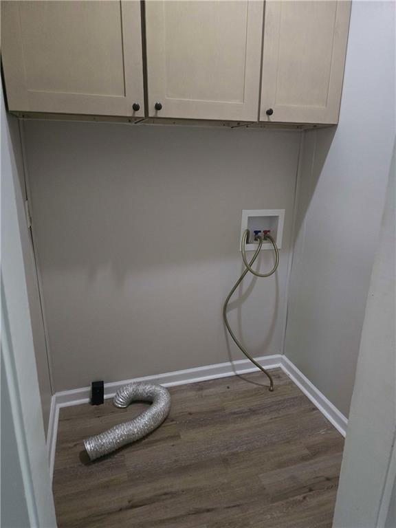 2863 Maysville Road Commerce, GA 30529 - Photo 12 of 15 a room with a wooden floor and cabinets