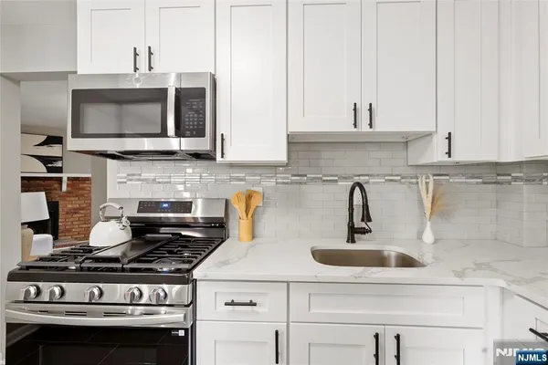 a kitchen with stainless steel appliances a stove and a microwave