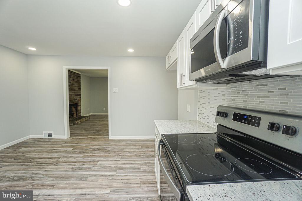 80 Skeet Road Medford, NJ 08055 - Photo 54 of 69 a kitchen with stainless steel appliances granite countertop a stove and a microwave oven