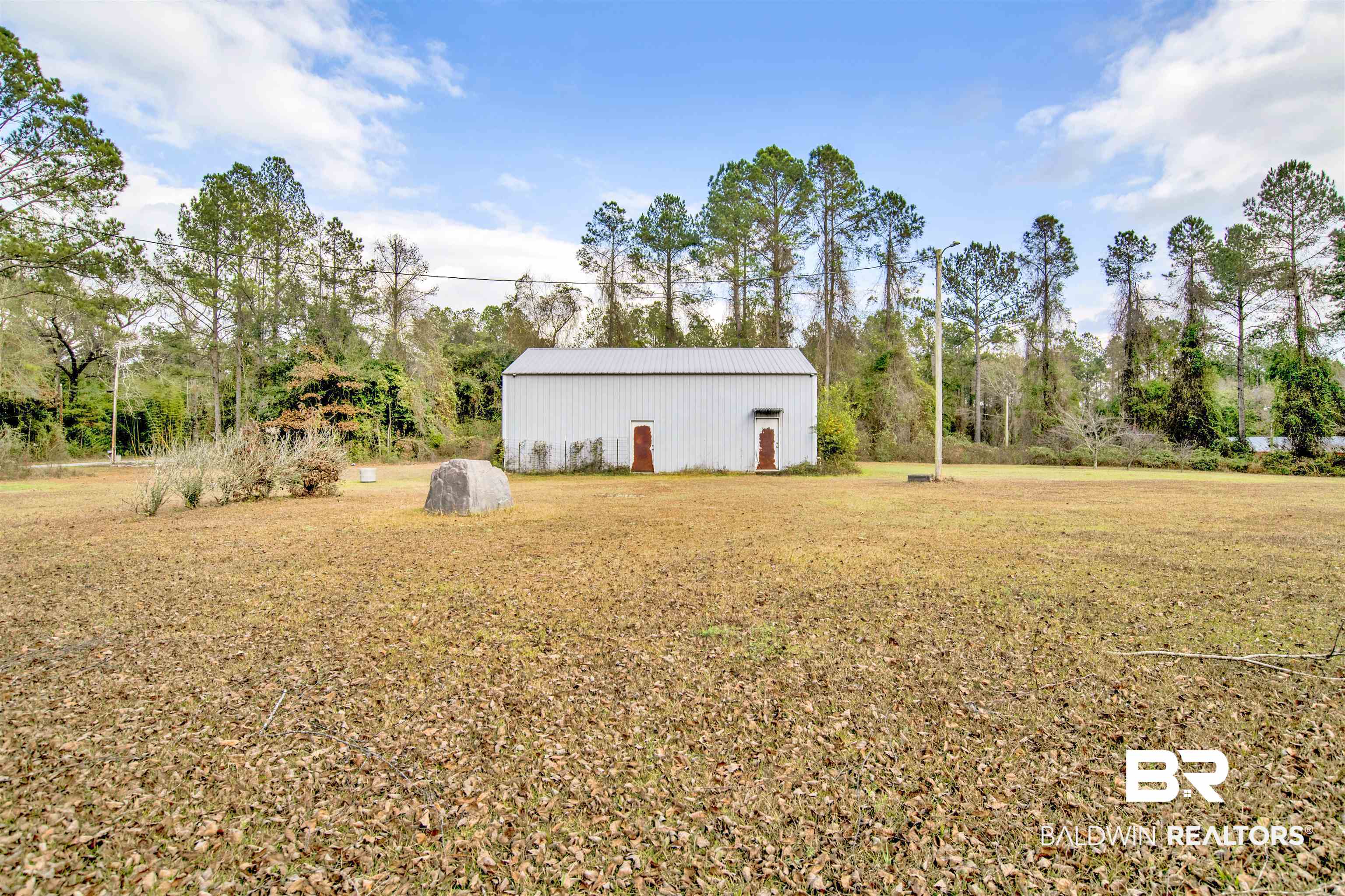 36434 Alexandria Trail Stapleton, AL 36578 - Photo 2 of 27 View of grassy yard featuring a pole building and an outdoor structure