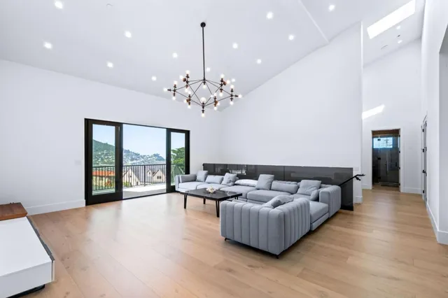a living room with furniture and a chandelier