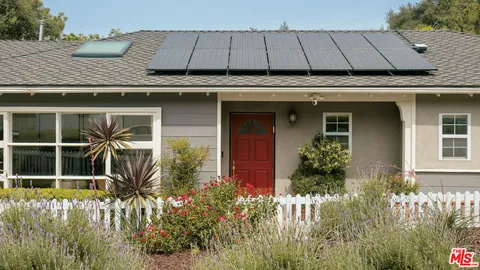 a view of a house with a flower garden