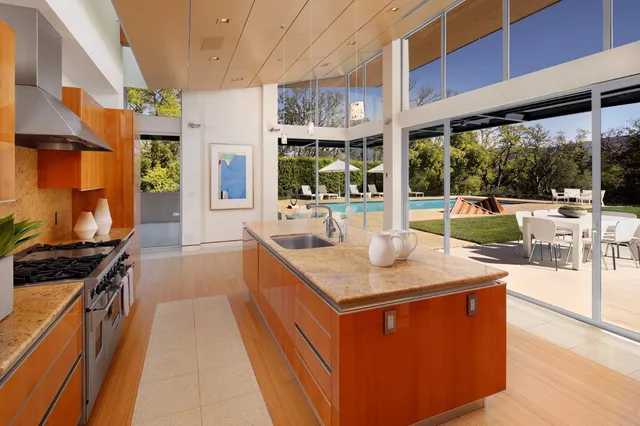 a kitchen with stainless steel appliances granite countertop a stove and a sink