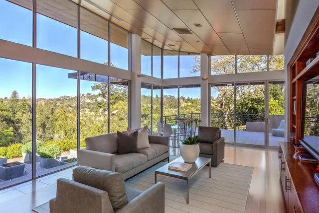 a living room with furniture and a floor to ceiling window
