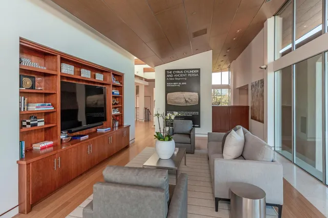a living room with furniture cabinets and a flat screen tv