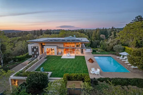 an aerial view of house with yard swimming pool and outdoor seating
