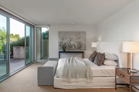 a bedroom with a bed and glass window