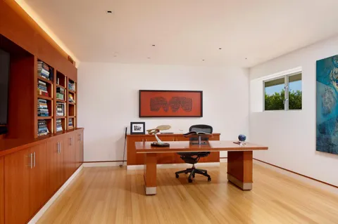 a workspace with furniture and wooden floor